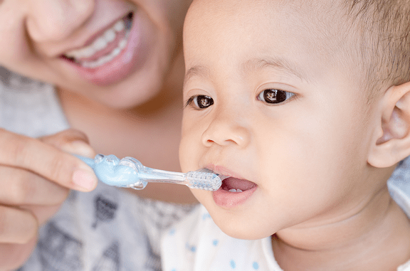 Baby biting on toothbrush