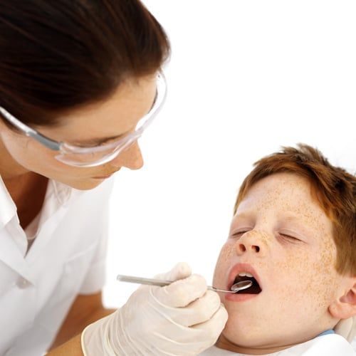 Dentist looking in child